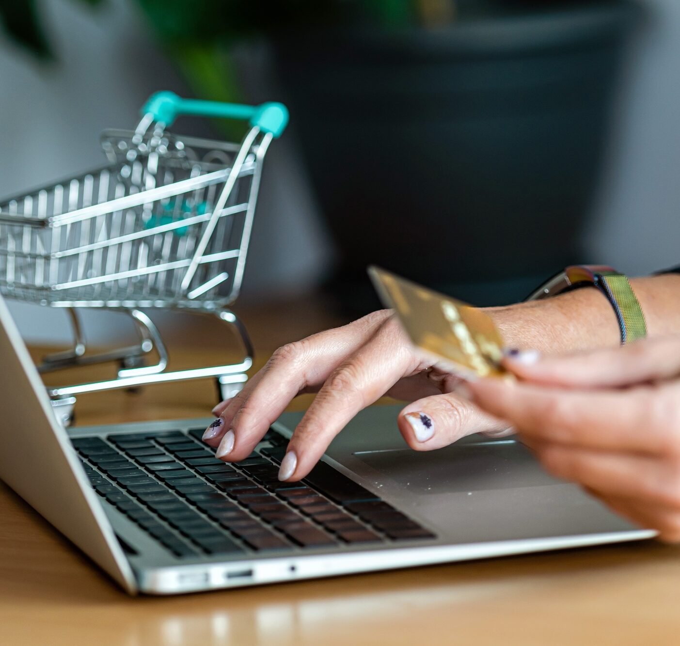 close-up of a woman hands buying online with a credit card and a laptop, e-commerce concept